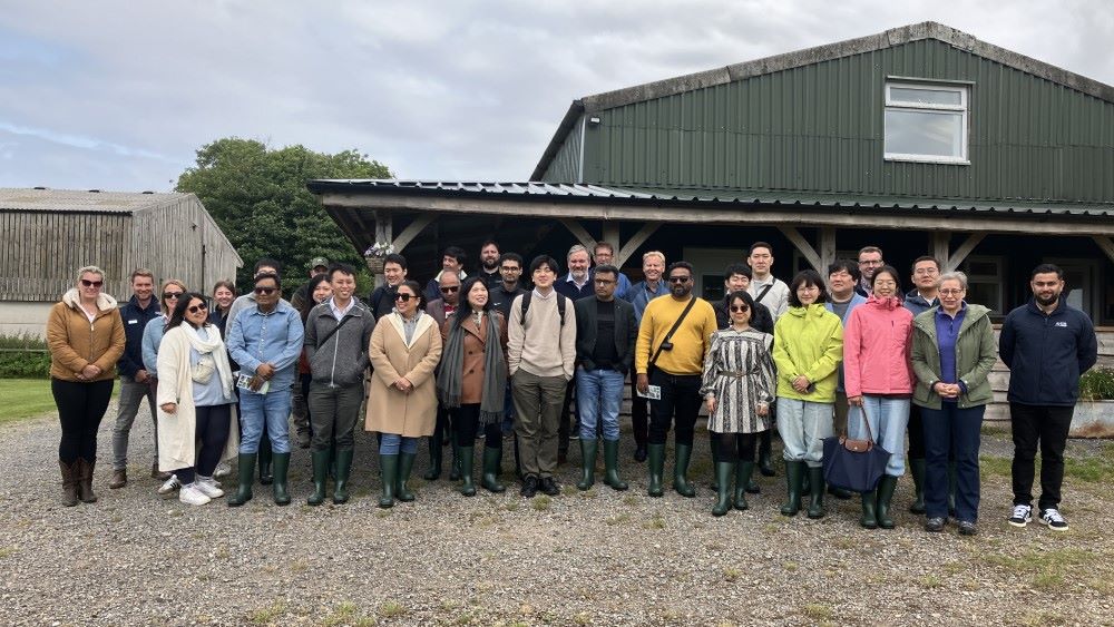 group of people in front of a barn