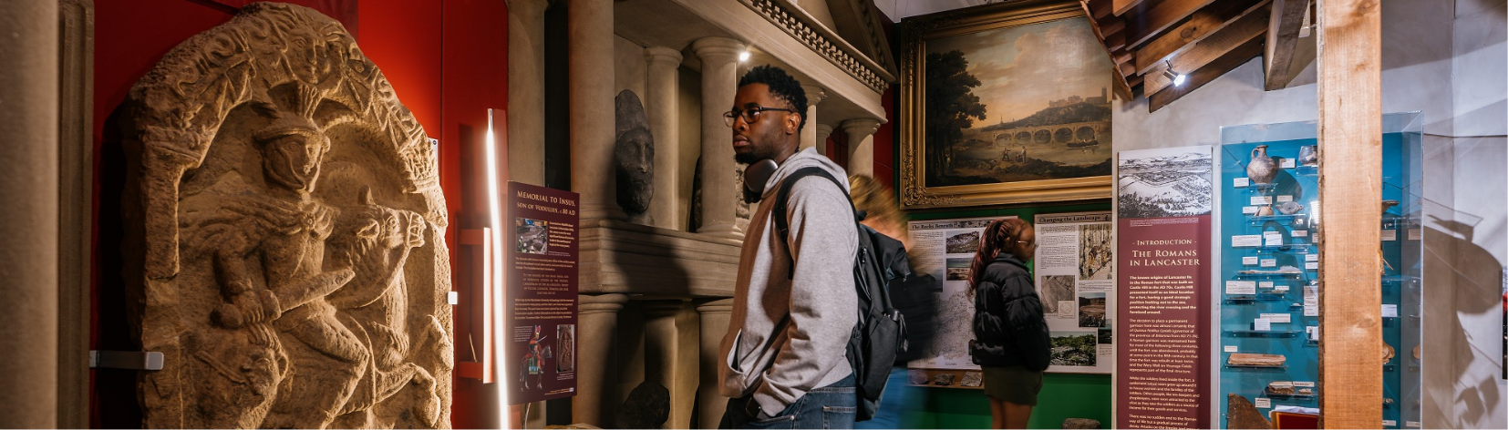 A person looking at an exhibition in a museum.