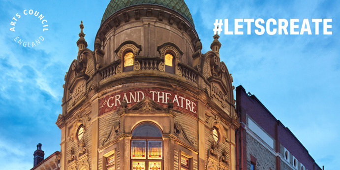 The front of the Grand Theatre, a large building with a dome roof and ornate windows.