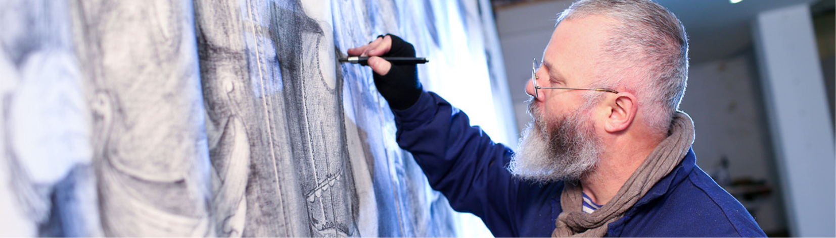 Pete Codling sketching faces onto a sail.
