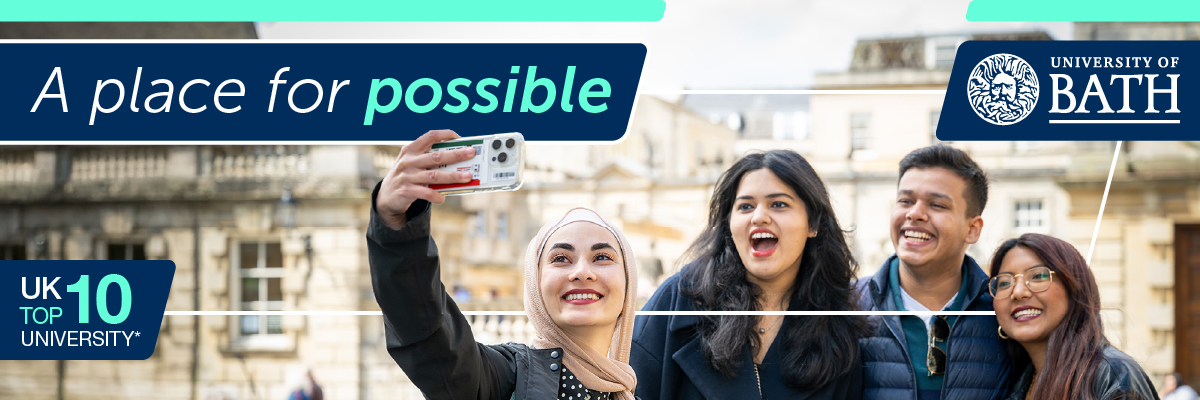 An image of four students smiling whilst taking a selfie on a mobile phone
