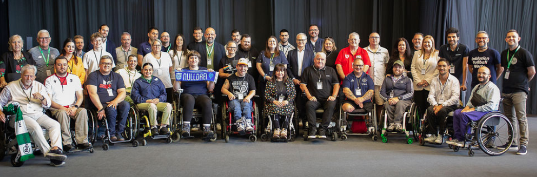 A large group photo of disability and inclusion football supporters from across Europe, including several wheelchair users, gathered at the Football Supporters Europe Disability and Inclusion Fan Network launch meeting in Malmö.