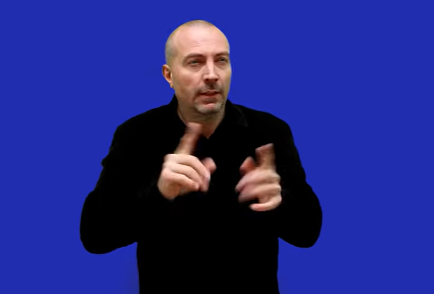  person communicating in sign language against a bright blue background.