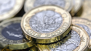 A close up of a few pound coins in a pile
