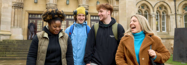 Students sat on benches at Clifton Campus