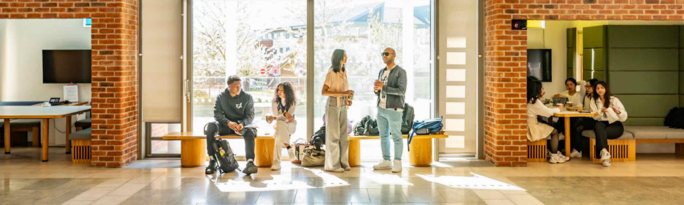 Students sat on benches at Clifton Campus