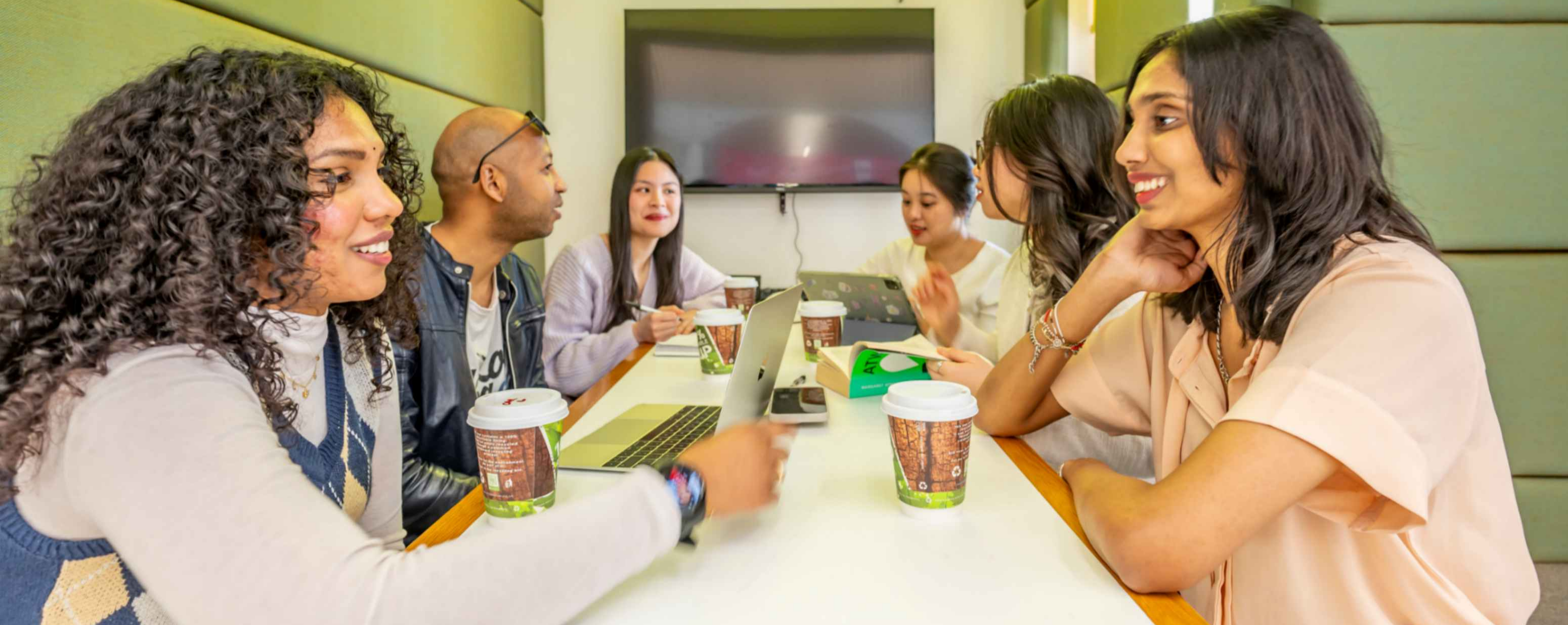 Students sat on benches at Clifton Campus